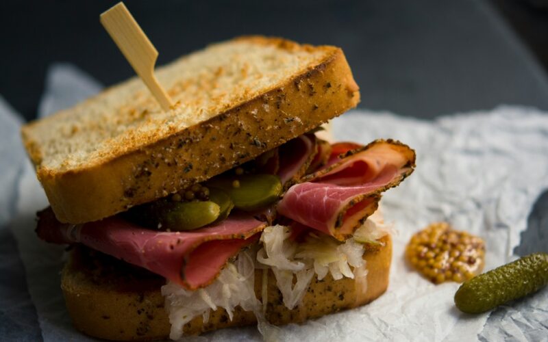 Un toast farcito con un salume cotto, olive, craturi e tostato