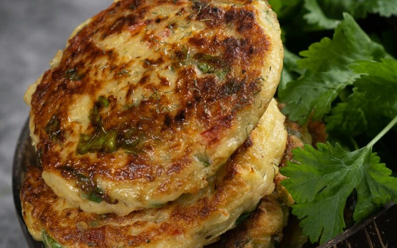 Un close up di due rosti impilati in un piatto affinacati a dell'insalata